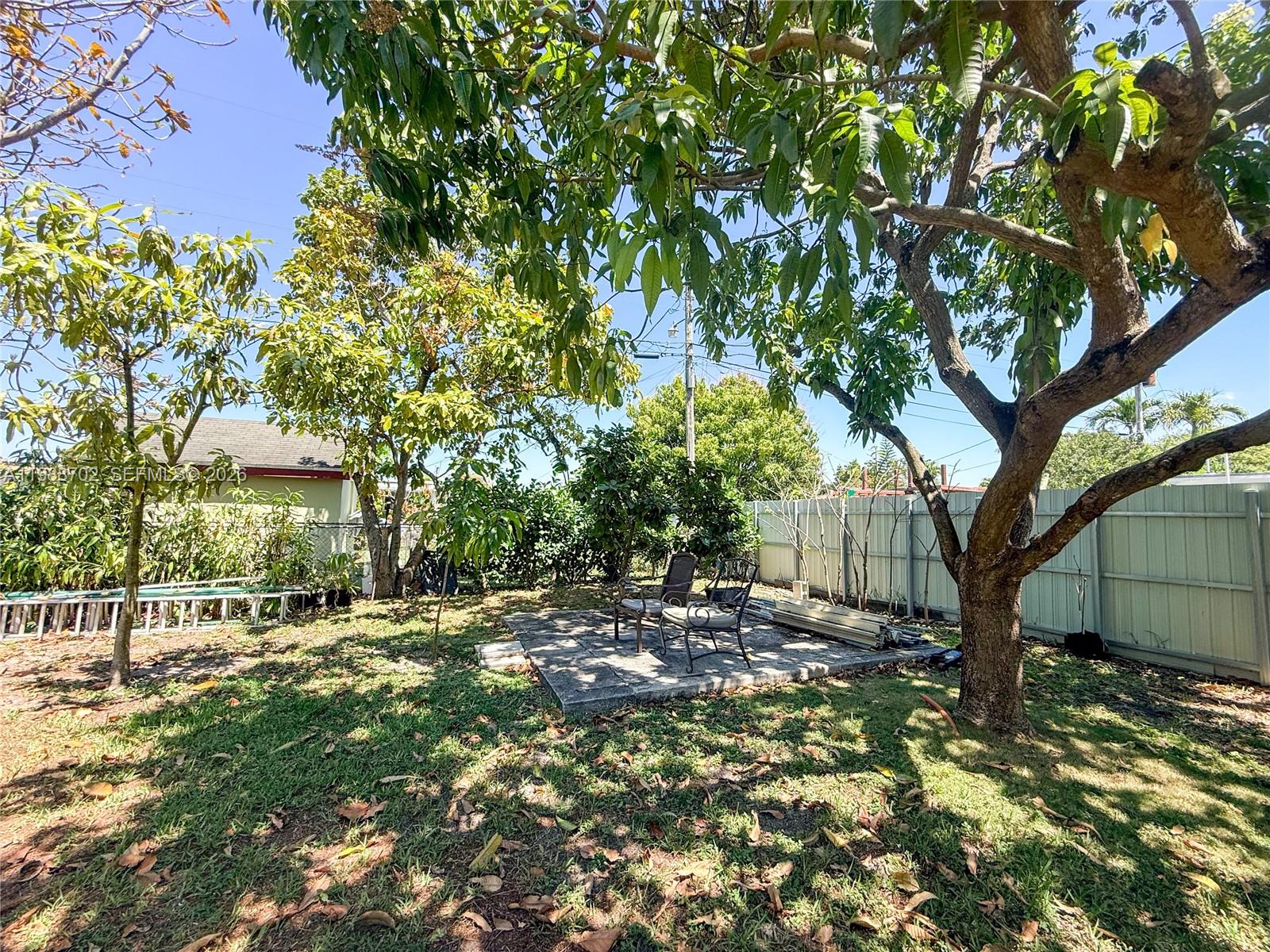 9971 Southwest 41st Terrace Miami, FL 33165 - Photo 21 of 21 a backyard of a house with lots of green space