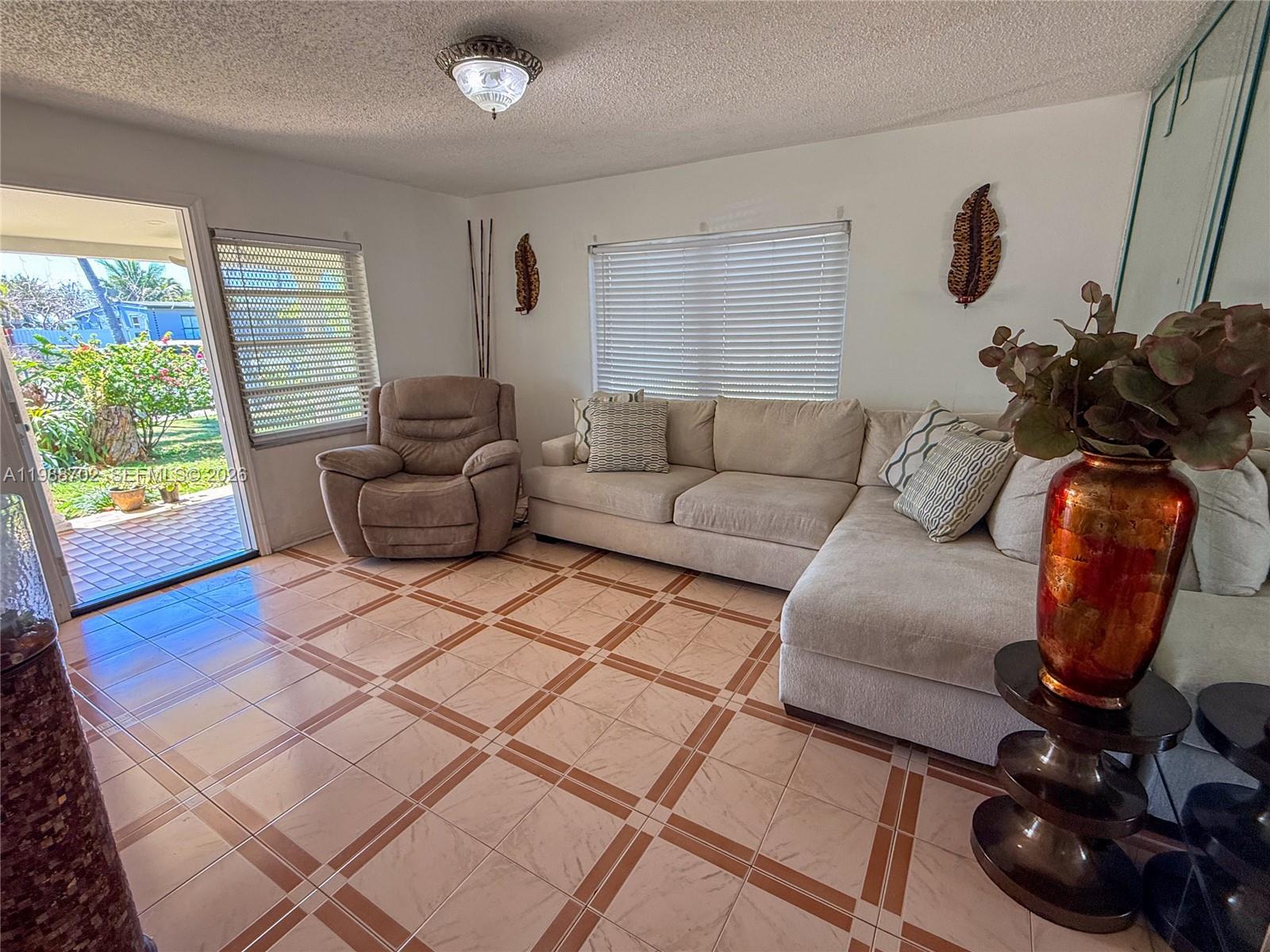 9971 Southwest 41st Terrace Miami, FL 33165 - Photo 7 of 21 a living room with furniture and a window
