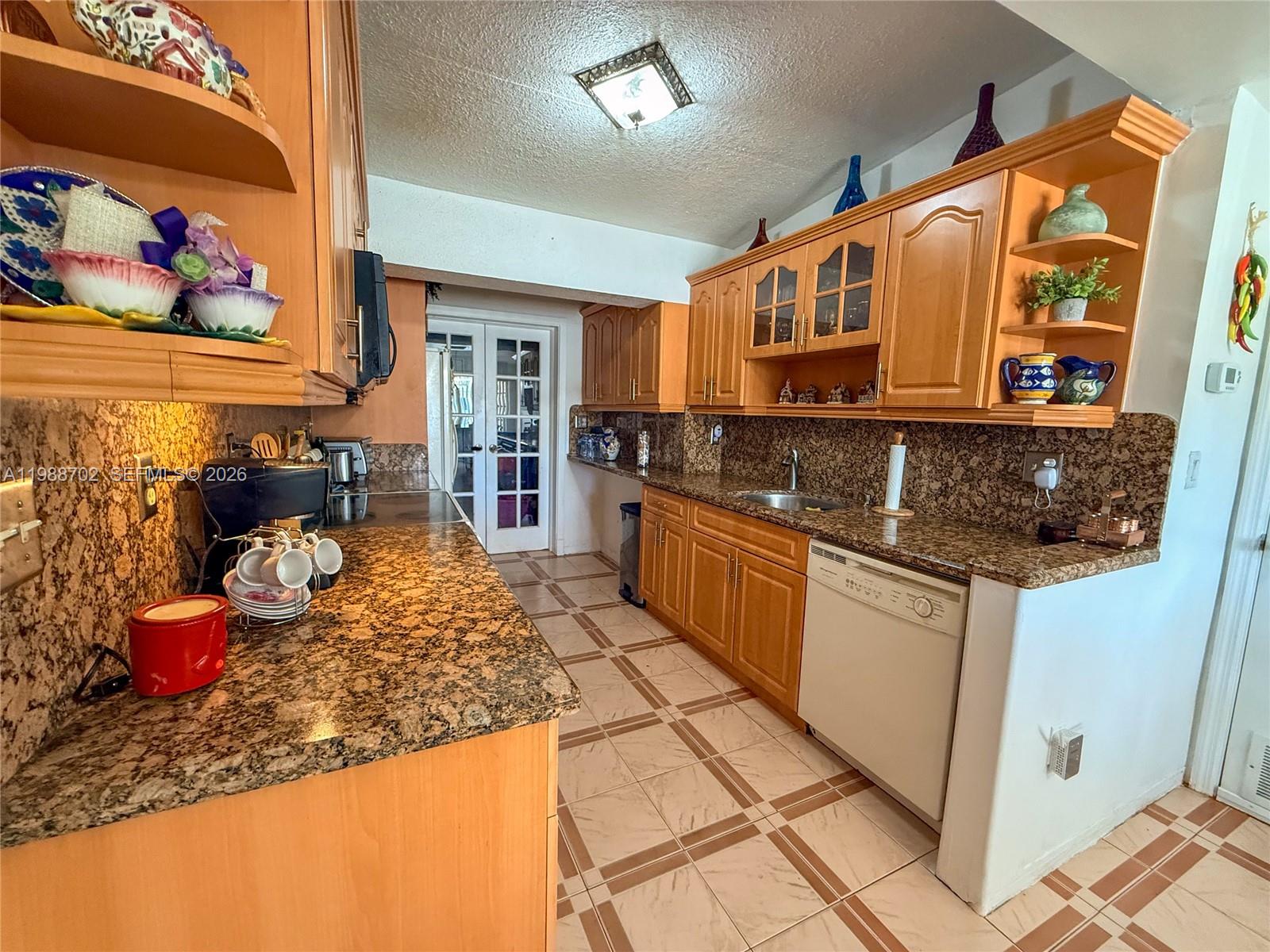 9971 Southwest 41st Terrace Miami, FL 33165 - Photo 10 of 21 a kitchen with a sink stove and cabinets