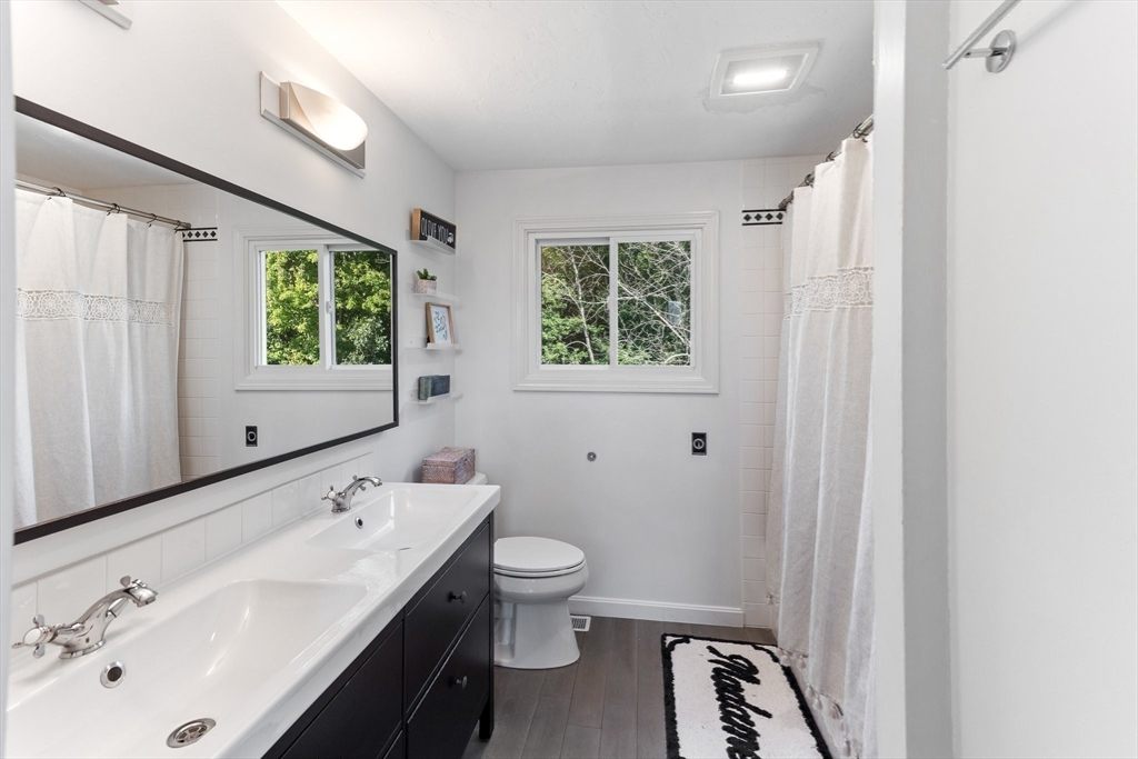 3 Forest Park Drive Mendon, MA 01756 - Photo 16 of 22 a bathroom with a double vanity sink a toilet and a mirror