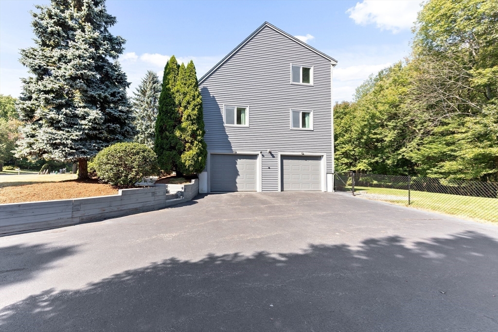 3 Forest Park Drive Mendon, MA 01756 - Photo 20 of 22 a front view of a house with a yard and garage