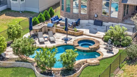 an aerial view of a house with swimming pool garden and patio