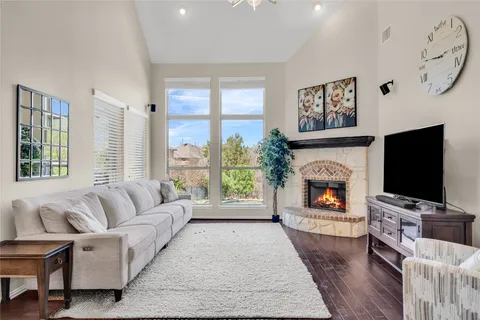a living room with furniture a flat screen tv and a fireplace