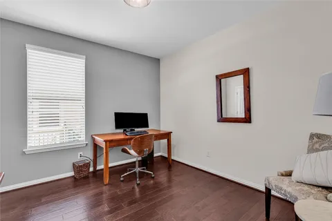 a view of a workspace with furniture and a window