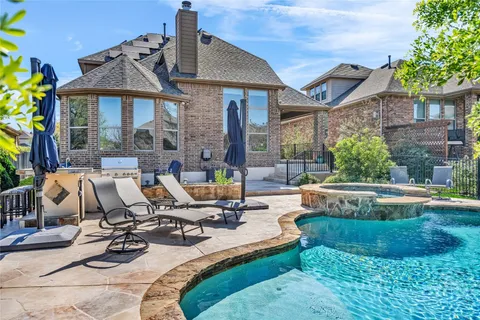 a view of a house with swimming pool and sitting area