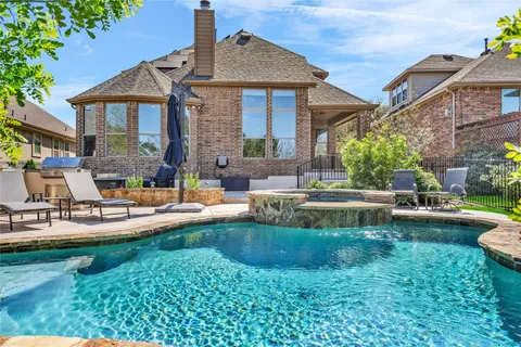 a view of a house with swimming pool and sitting area