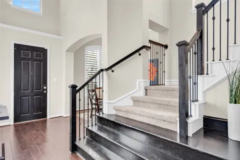 a view of entryway and hall with wooden floor
