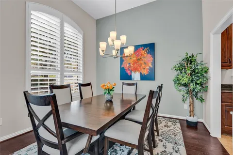 a dining room with furniture and wooden floor