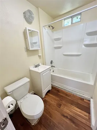 a bathroom with a toilet a sink and a shower