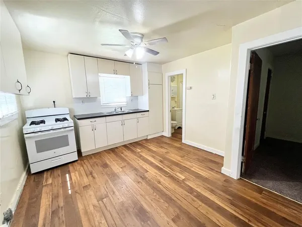 a kitchen with stainless steel appliances a stove top oven and sink