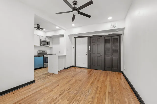 a view of a kitchen with a sink and a refrigerator