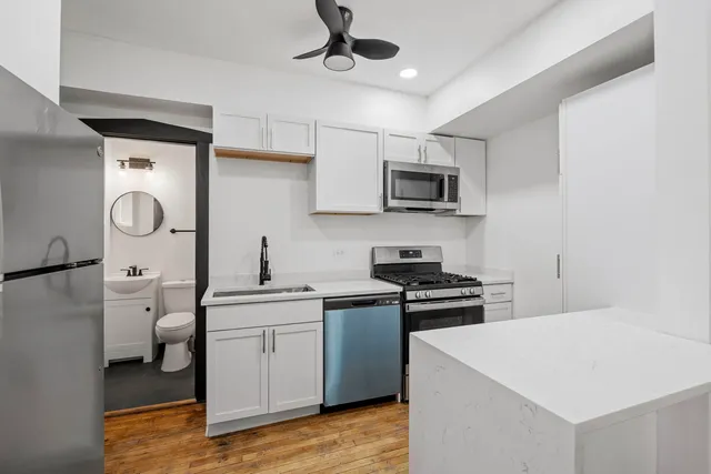 a kitchen with a sink a stove and refrigerator
