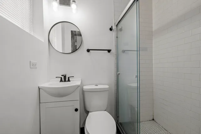 a bathroom with a toilet a sink and a mirror