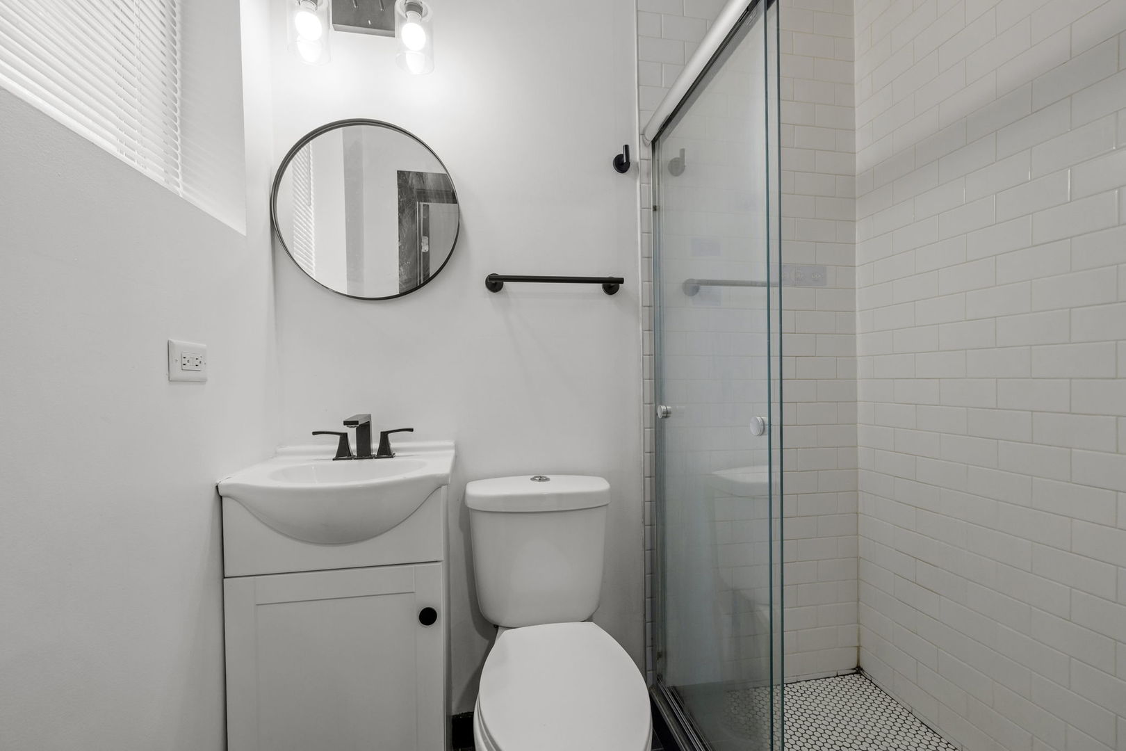 7202 South Indiana Avenue, Unit 1R Chicago, IL 60619 - Photo 6 of 9 a bathroom with a toilet a sink and a mirror