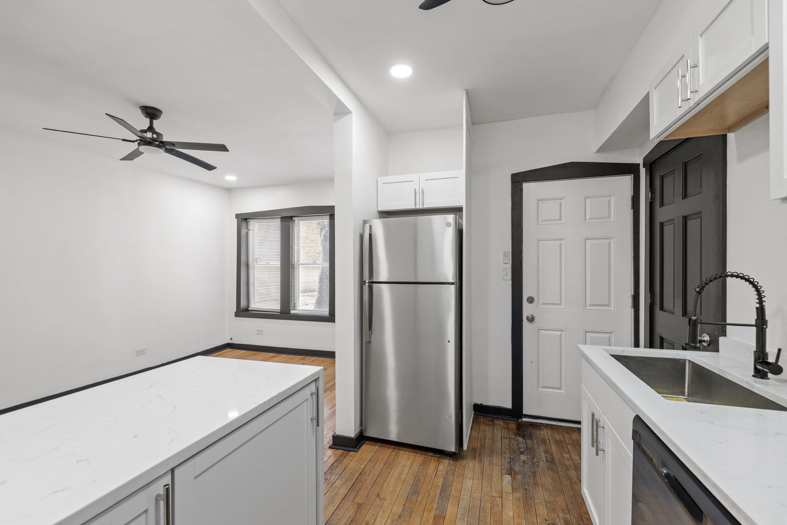 7202 South Indiana Avenue, Unit 1R Chicago, IL 60619 - Photo 7 of 9 a kitchen with a refrigerator sink and cabinets