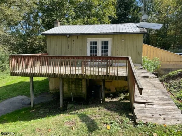 a view of a house with a porch and furniture