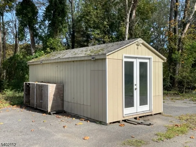 a view of a wooden door and yard