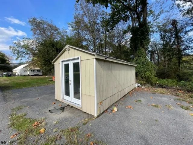 a view of a small house with a yard