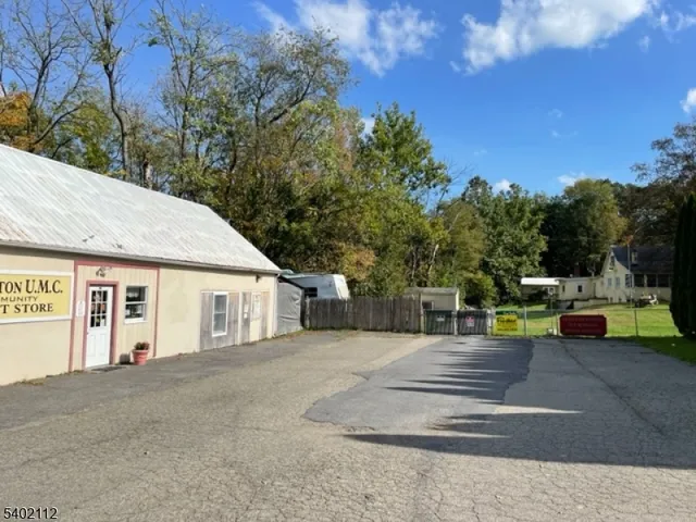 a view of a house with pool and sitting area