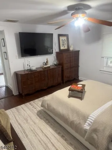 a bedroom with a bed and flat screen tv