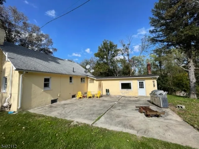 a backyard of a house with table and chairs