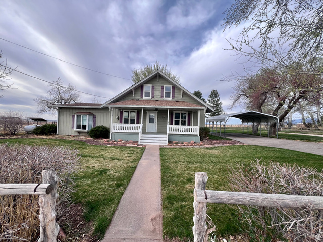 479 East 100 N Road Meadow, UT 84644 - Photo 59 of 59 Bungalow-style home featuring a front yard, covered porch, a carport, a shingled roof, and driveway