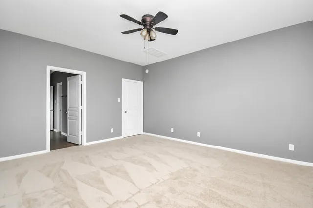a view of a room with a ceiling fan