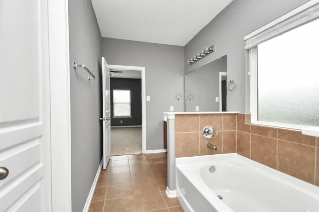 a bathroom with a bathtub and a shower