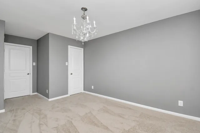 a view of a chandelier in big room and chandelier