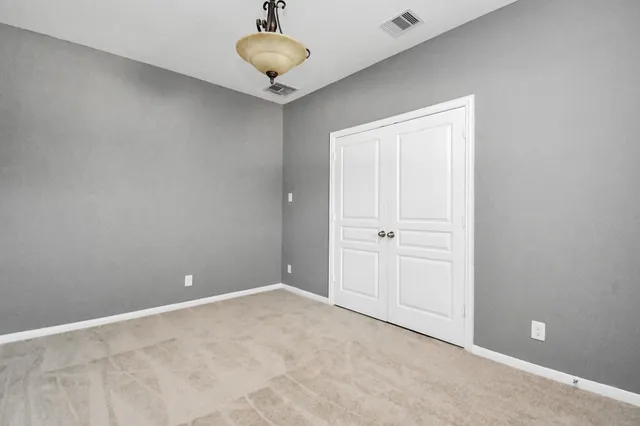 a view of an empty room and a ceiling fan
