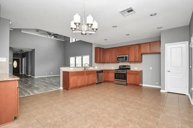 a open kitchen with cabinets a sink and stainless steel appliances