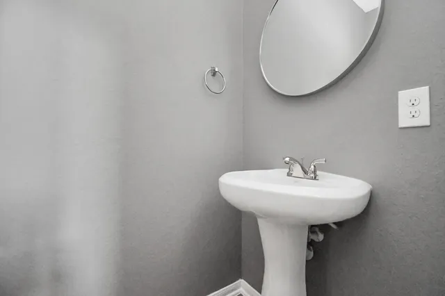 a bathroom with a sink a mirror and a toilet
