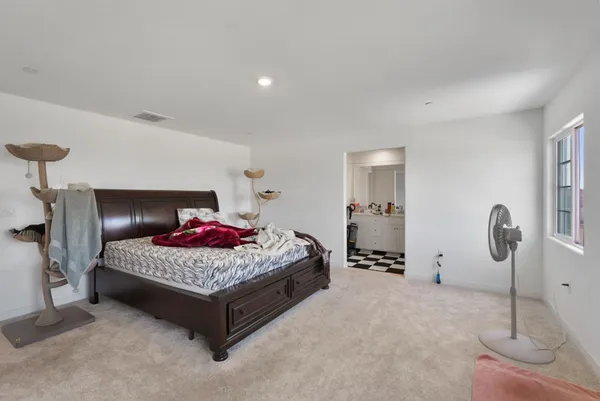 a bedroom with a bed and window