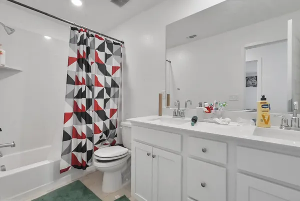 a bathroom with a sink a toilet and a shower