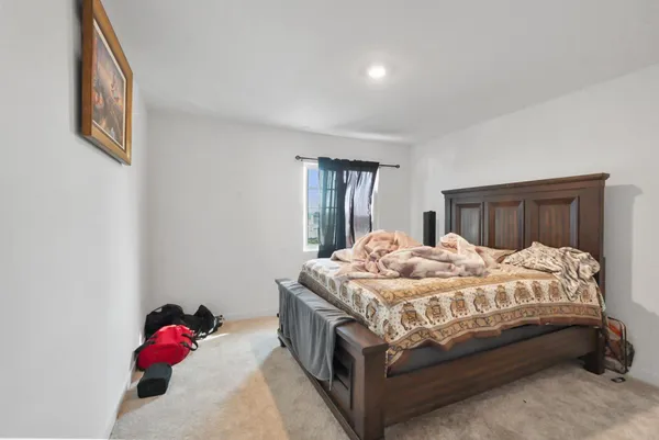a bedroom with a bed and a dresser