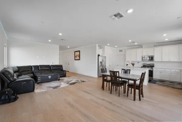 a living room with furniture and kitchen view