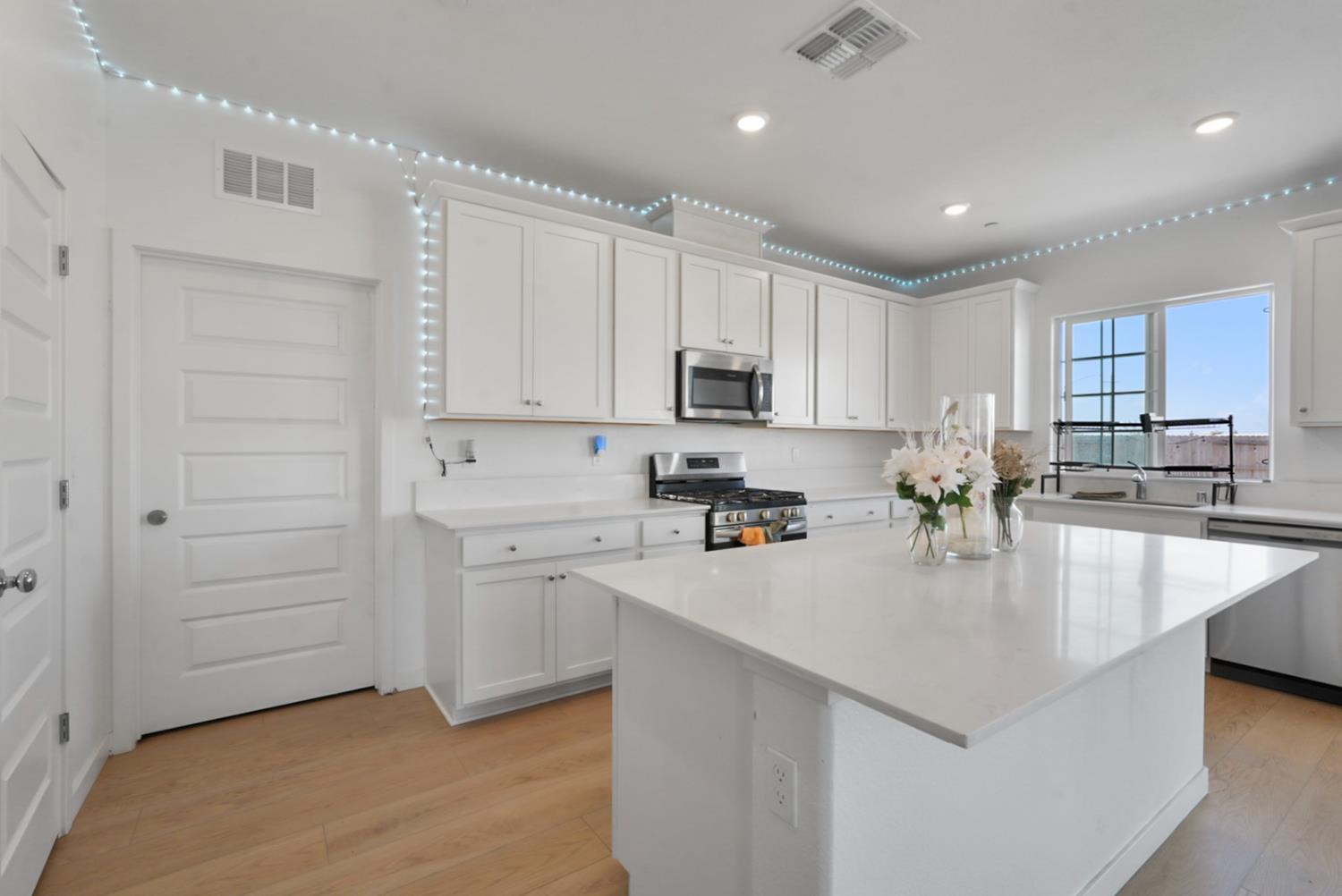 7041 Overlook Way Stockton, CA 95219 - Photo 21 of 31 a kitchen with kitchen island a white counter top space cabinets and stainless steel appliances