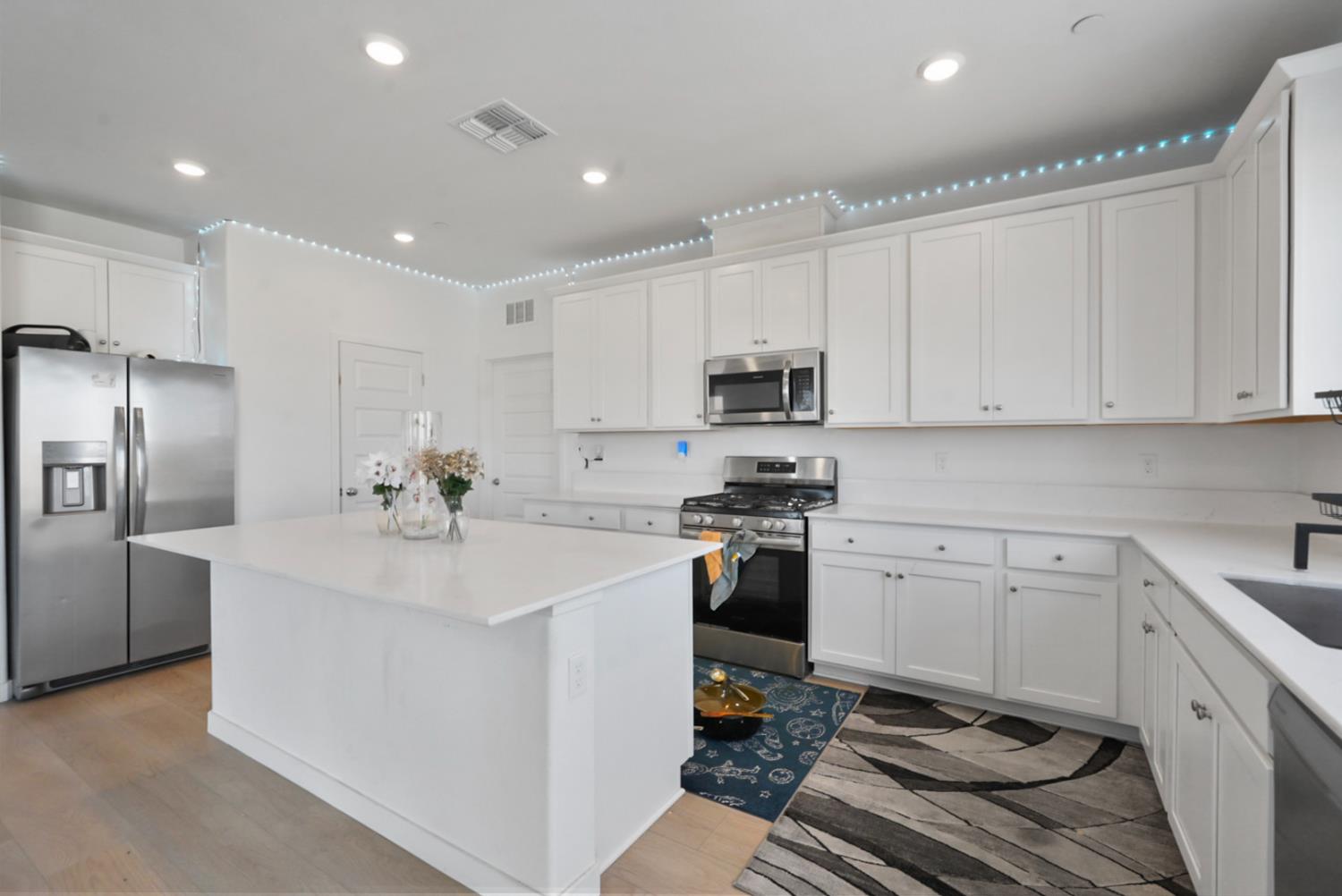 7041 Overlook Way Stockton, CA 95219 - Photo 22 of 31 a kitchen with a sink stainless steel appliances and white cabinets