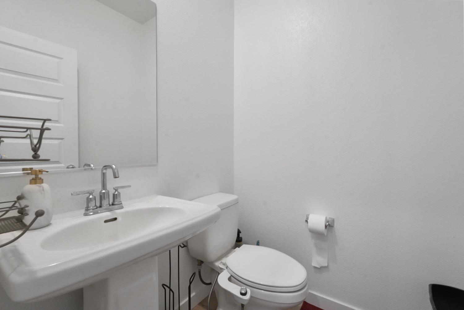 7041 Overlook Way Stockton, CA 95219 - Photo 24 of 31 a bathroom with a sink mirror and toilet