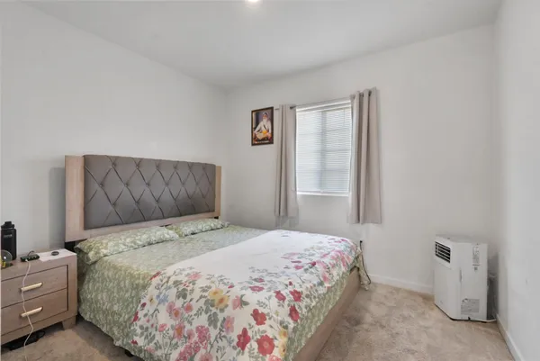 a bedroom with a bed and a window