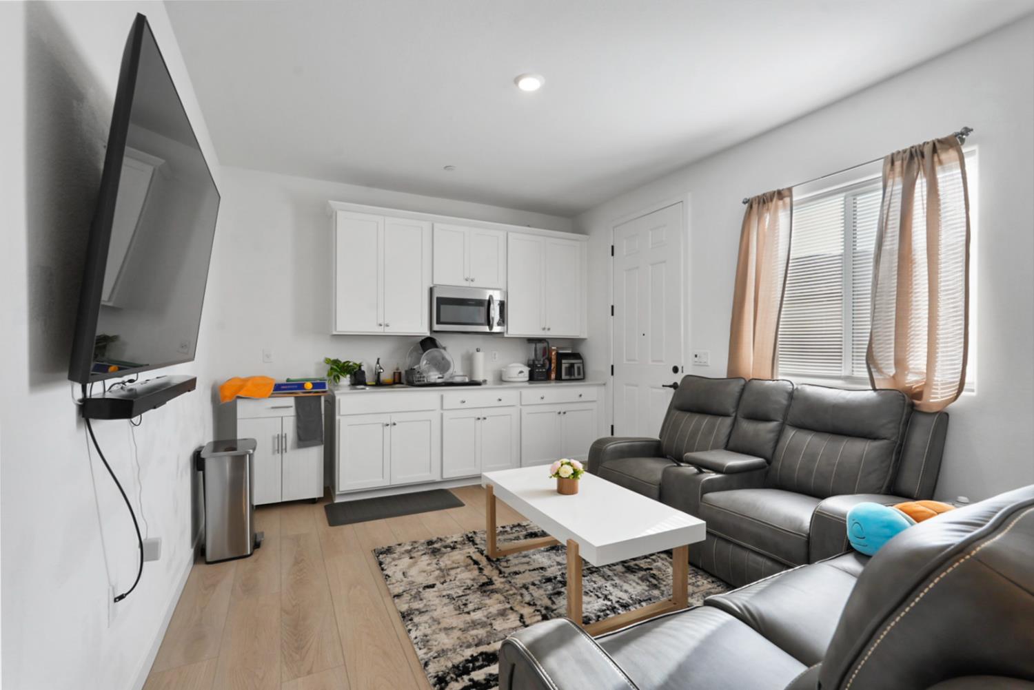 7041 Overlook Way Stockton, CA 95219 - Photo 29 of 31 a living room with furniture and a flat screen tv