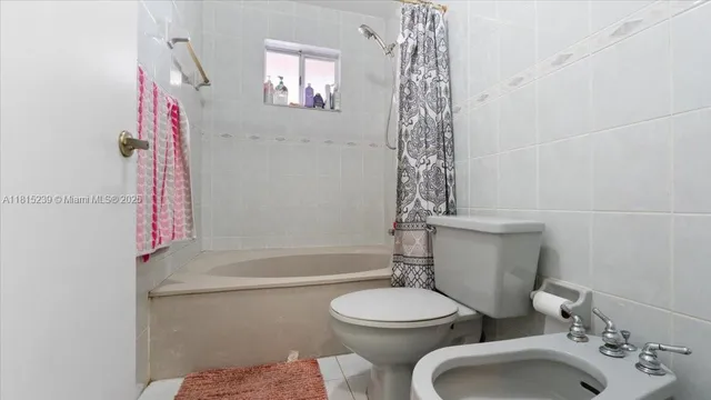 a bathroom with a toilet sink and shower