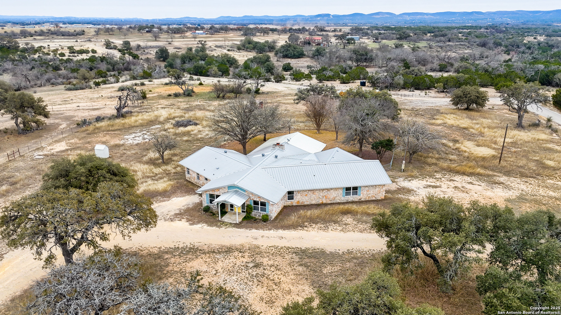 an aerial view of a house with yard