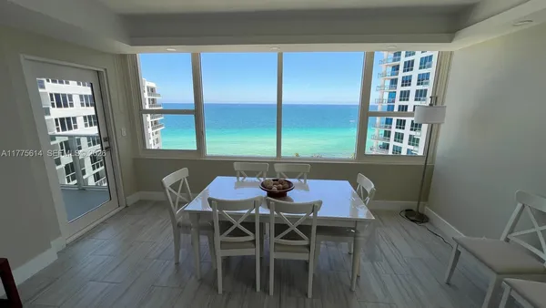 a view of a dining room with furniture and window
