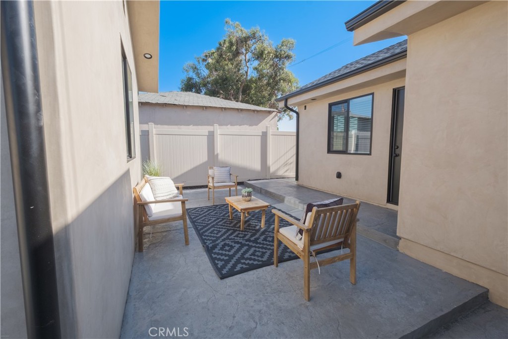 223 South Aprilia Avenue Compton, CA 90220 - Photo 28 of 46 a view of a patio with a dining table and chairs