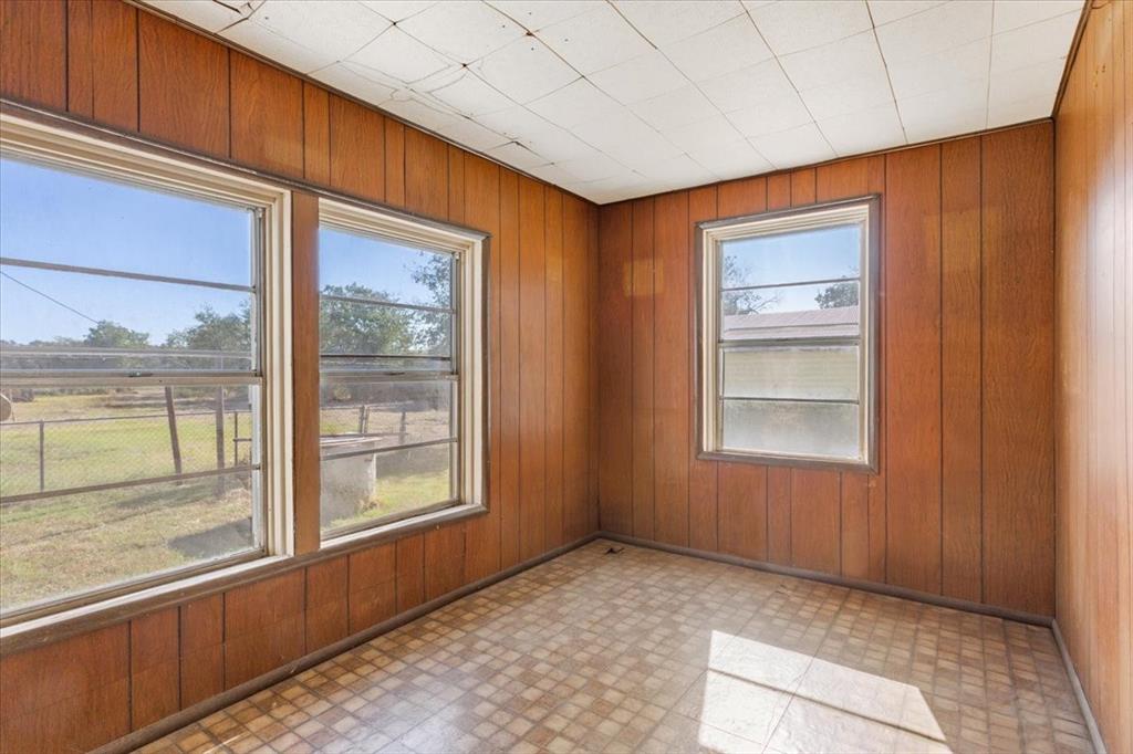 100 County Road 120 C Riesel, TX 76682 - Photo 14 of 25 Empty room featuring wood walls and light flooring