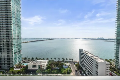 a view of a lake with a city skyline in the background