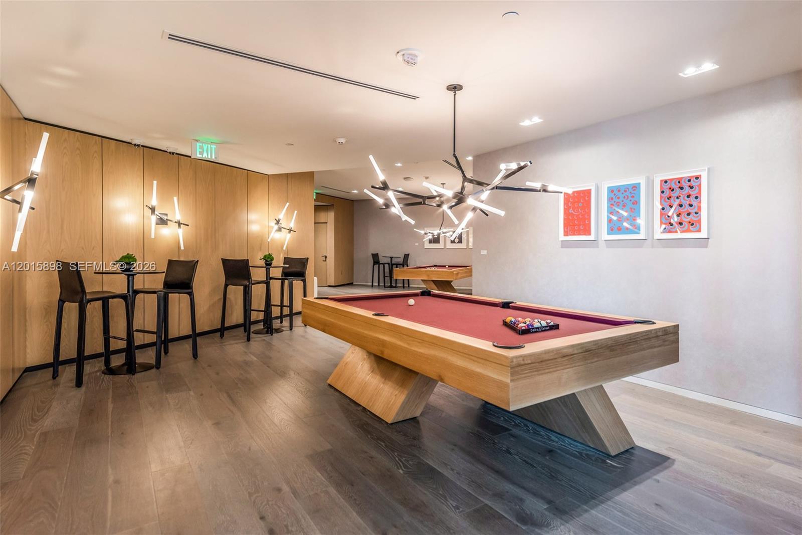 480 Northeast 31st Street, Unit 1802 Miami, FL 33137 - Photo 41 of 50 a room with wooden floor pool table and chairs