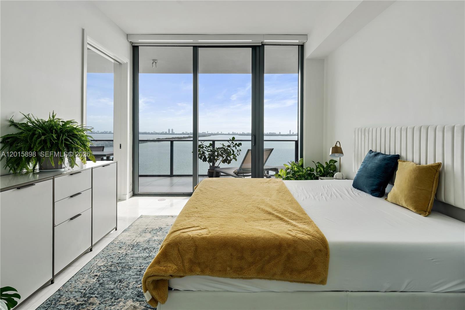 480 Northeast 31st Street, Unit 1802 Miami, FL 33137 - Photo 6 of 50 a bed sitting in a spacious bedroom next to a large window