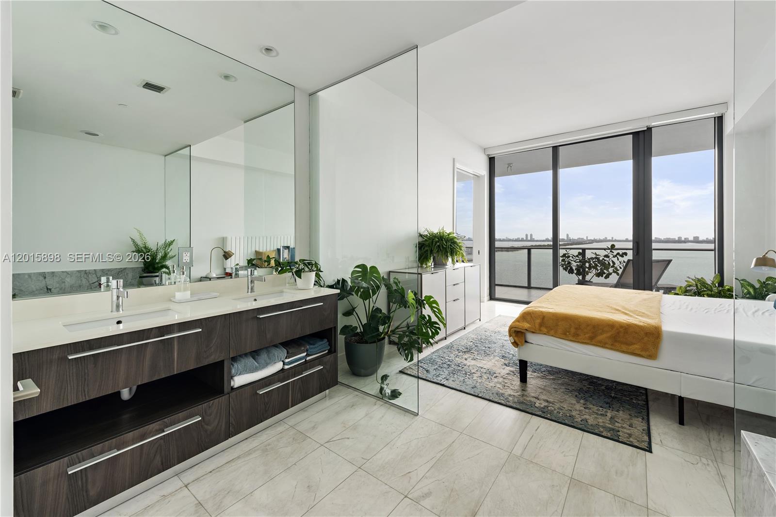 480 Northeast 31st Street, Unit 1802 Miami, FL 33137 - Photo 7 of 50 a spacious bathroom with a double vanity and a large mirror next to a large window